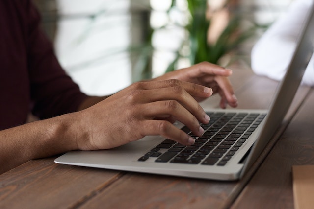 Close up of someone working on their laptop